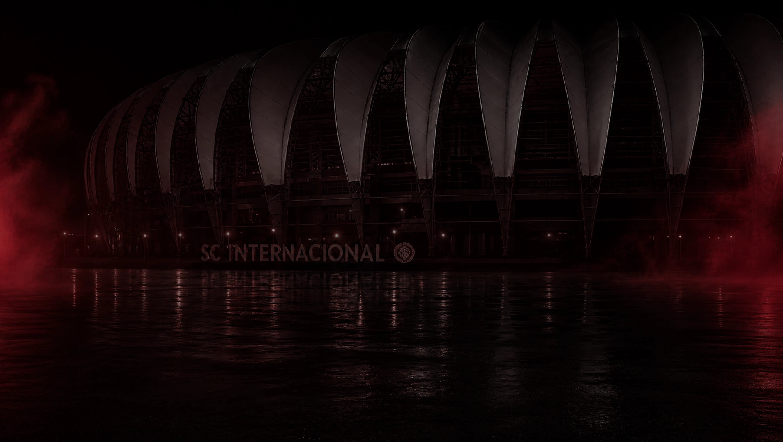 Estádio Beira-Rio à noite com atmosfera vermelha